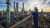 An engineer on a gangway surveys a gas production site